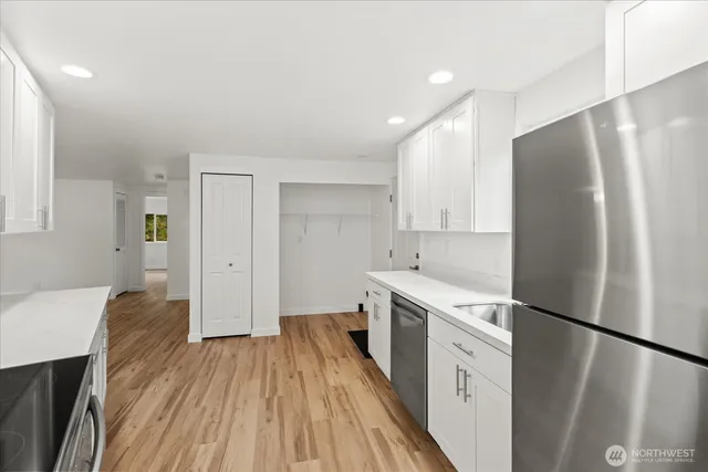 a kitchen with a refrigerator a sink and dishwasher