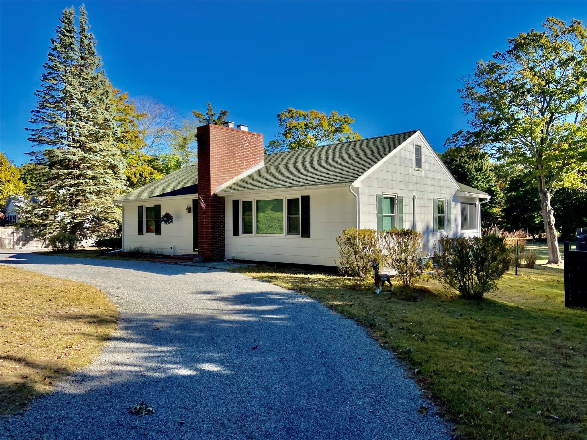 Ranch-style home featuring a front lawn