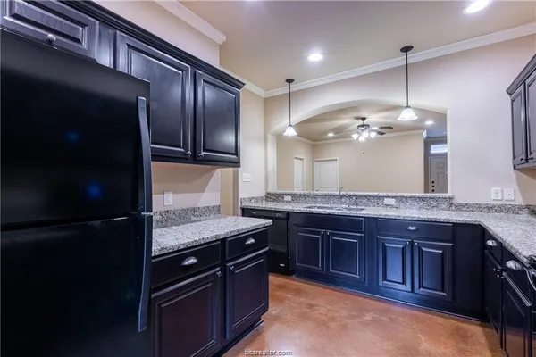 a kitchen with a stove and a wooden cabinets