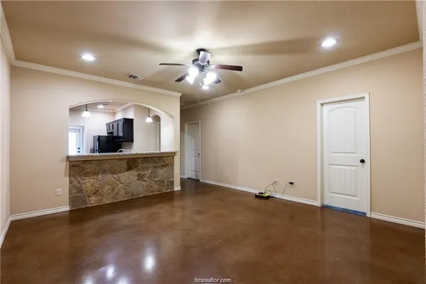 a view of a room with a faucet and ceiling fan