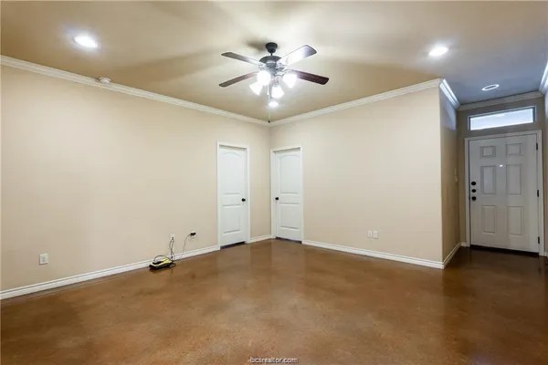 an empty room with a ceiling fan and wooden floor