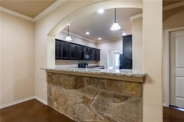 a large kitchen with a table and chairs in it