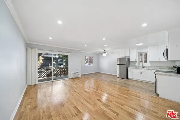 a view of large kitchen with a sink and cabinets