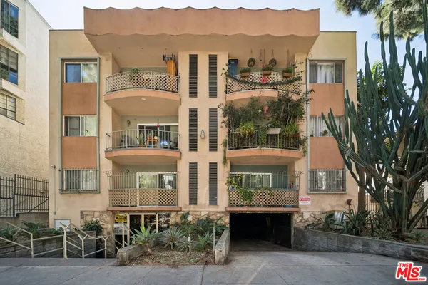 a front view of a house with a yard and balcony