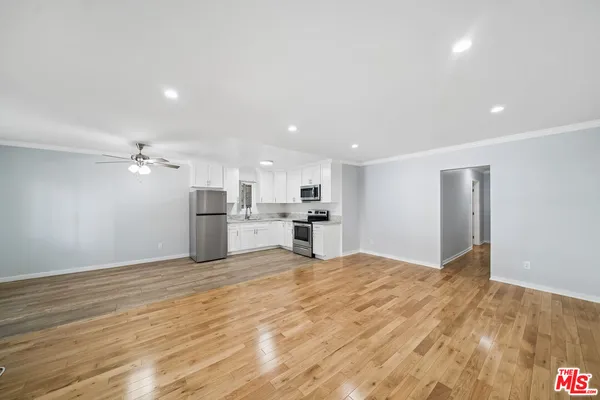 a view of a kitchen with microwave and cabinets