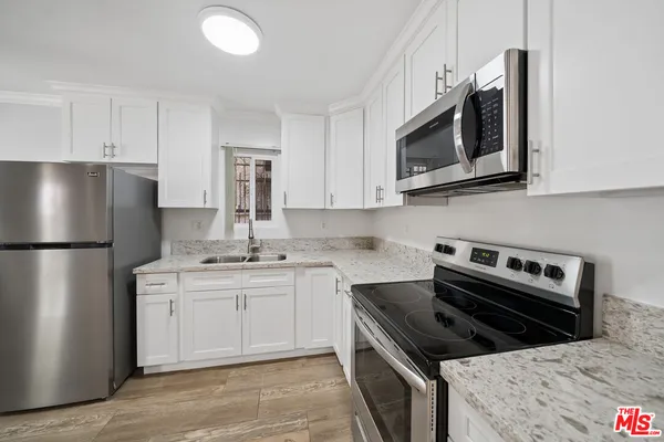 a kitchen with a stove microwave and refrigerator