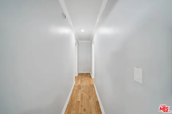 a view of gallery with wooden floor