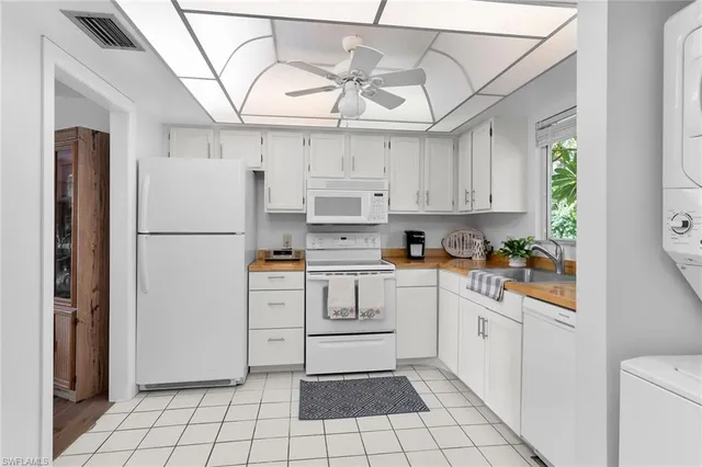 a kitchen with stainless steel appliances a refrigerator sink and cabinets