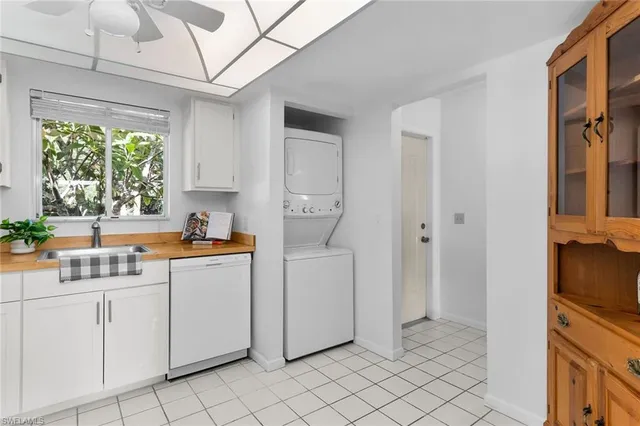 a kitchen with a sink cabinets and window