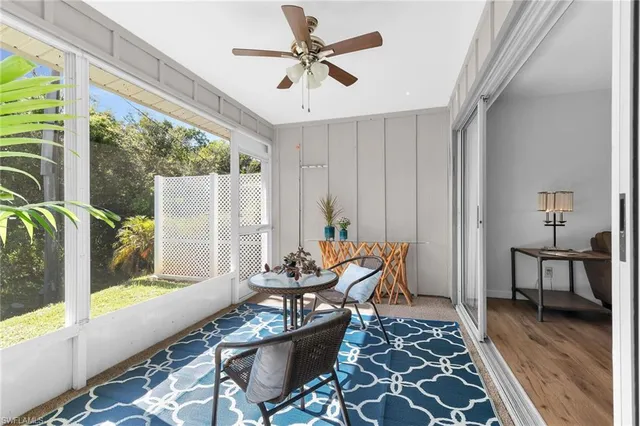 a dining room with furniture a chandelier and wooden floor