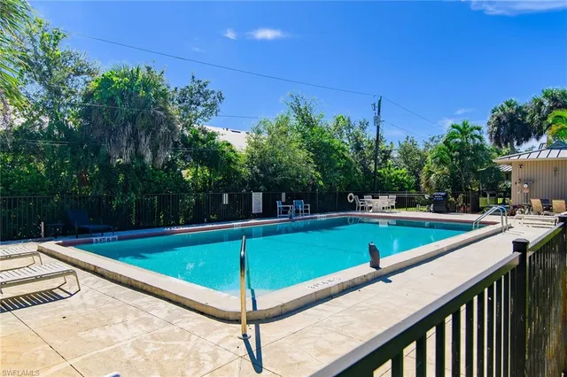 a view of a tennis court with a small pool