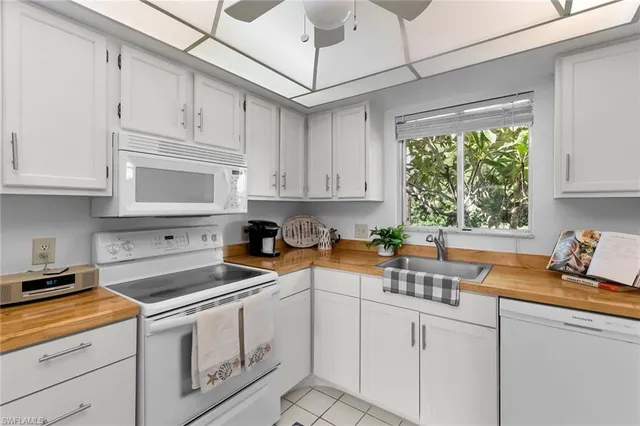 a kitchen with stainless steel appliances granite countertop a sink a stove and cabinets