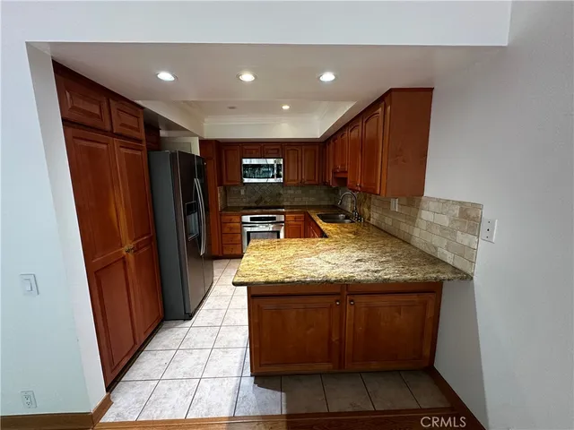 a view of a room with wooden floor a ceiling fan and windows