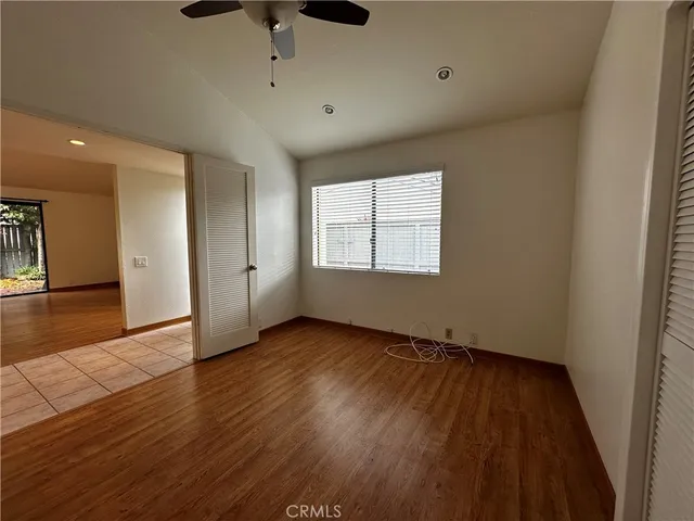 a view of a kitchen with wooden floor and a ceiling fan