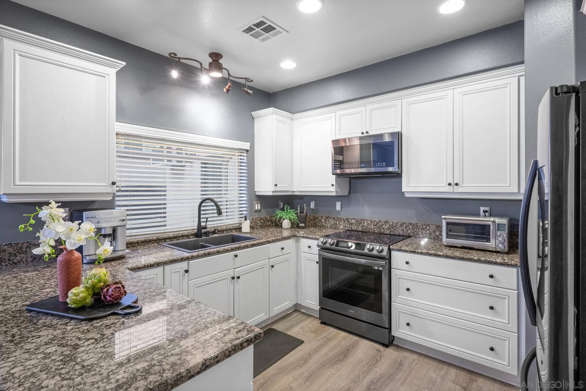 640 Dimaio Way Escondido, CA 92027 - Photo 12 of 31 a kitchen with granite countertop a sink stainless steel appliances and cabinets