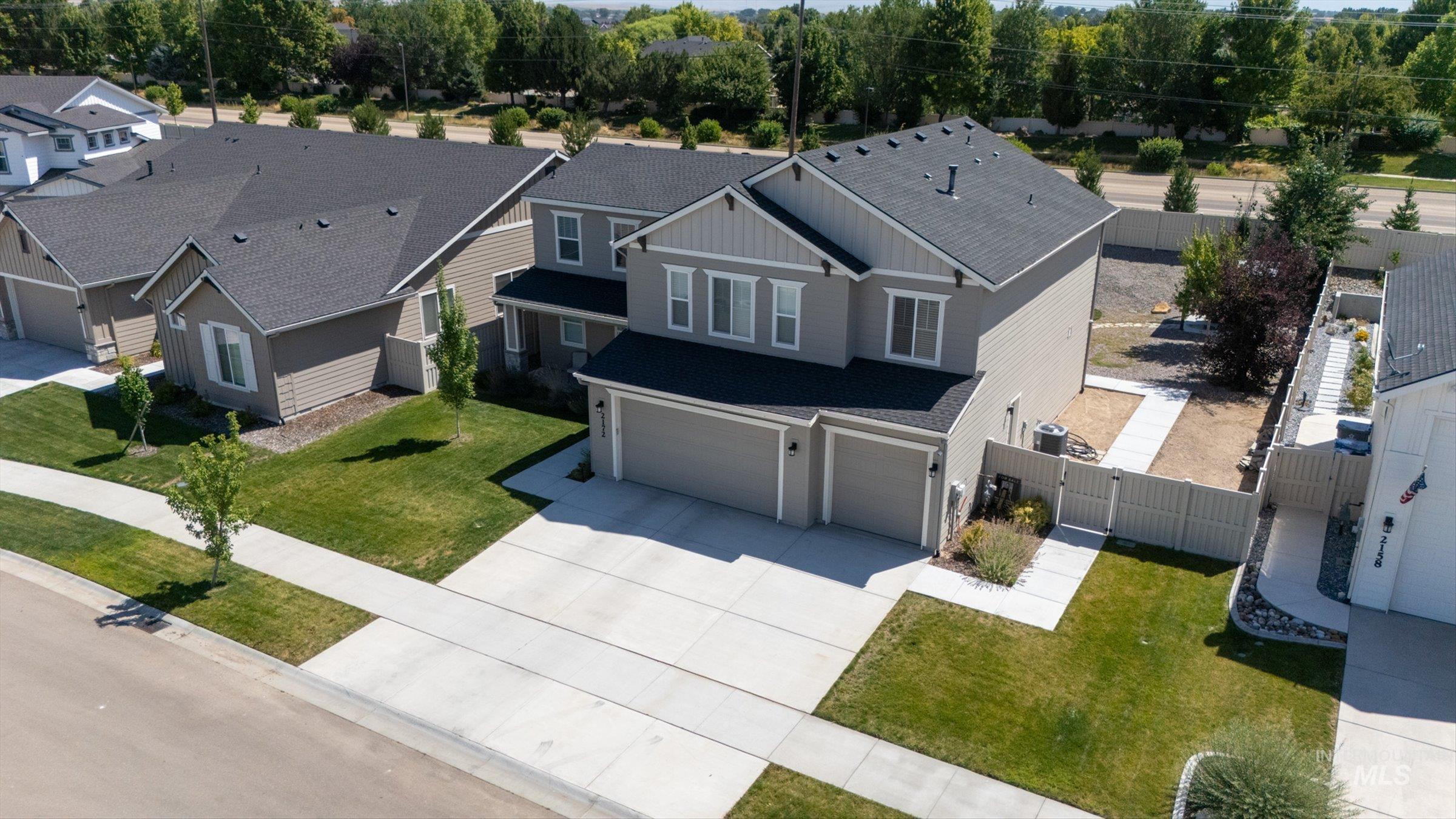 2172 Savoy Court Middleton, ID 83644 - Photo 34 of 46 Contemporary two-story residence featuring a two-car garage, a paved driveway, and a concrete walkway