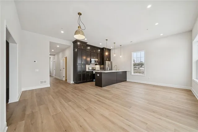 a view of kitchen and hall with wooden floor