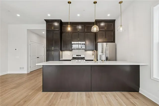 a large kitchen with a wooden floor and a large window