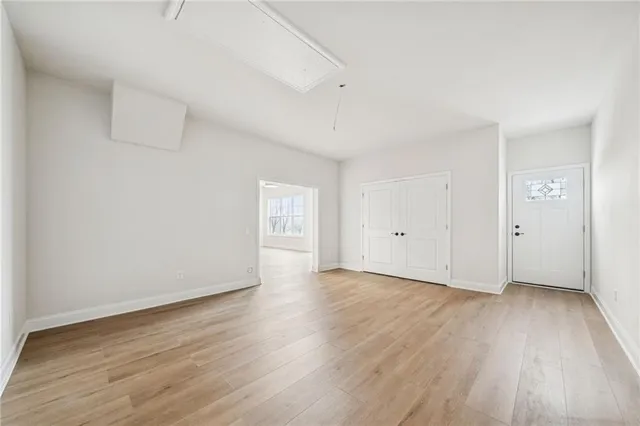 a view of an empty room and wooden floor