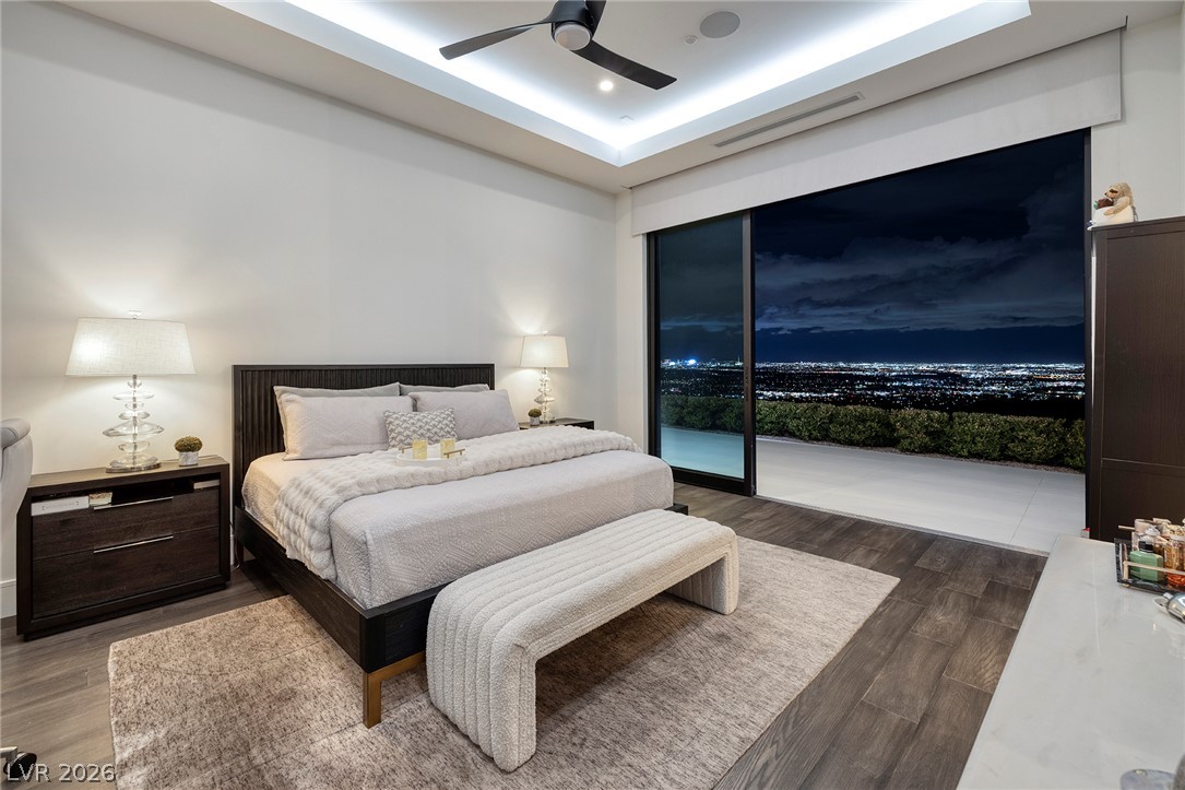 611 Cityview Ridge Drive Henderson, NV 89012 - Photo 47 of 66 Sliding glass doors frame sweeping city light views from this tranquil bedroom retreat.