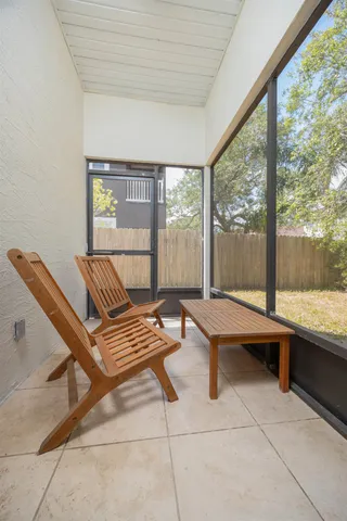 a outdoor space with a large window and sitting area