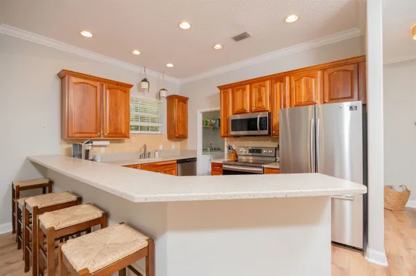 a kitchen with stainless steel appliances a sink and a refrigerator