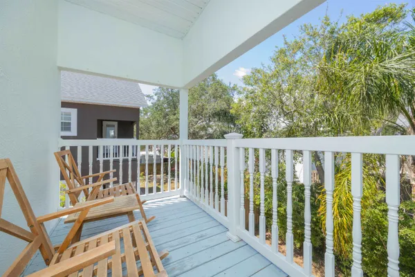 a view of a balcony with wooden floor