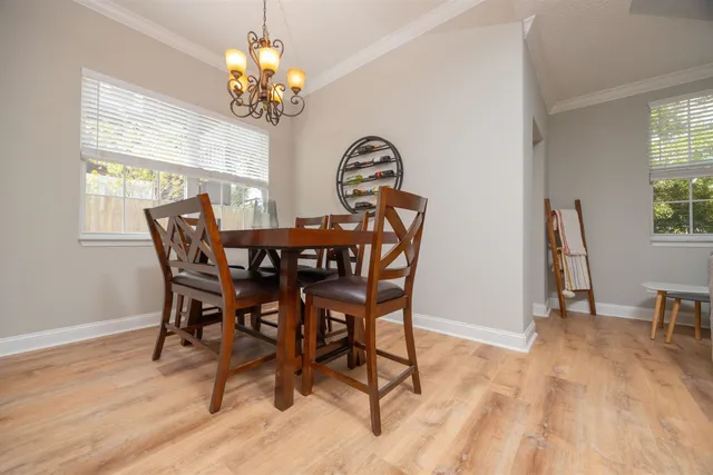 a view of a dining room with furniture and chandelier
