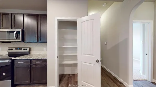 a bathroom with a sink a toilet and a window