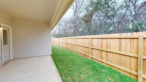 a view of a backyard with fence