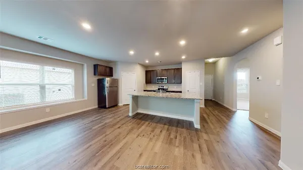a view of kitchen with refrigerator and window