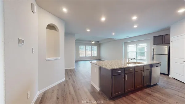 a kitchen with a sink and refrigerator