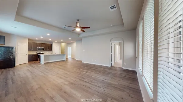 a view of kitchen with livingroom and wooden floor