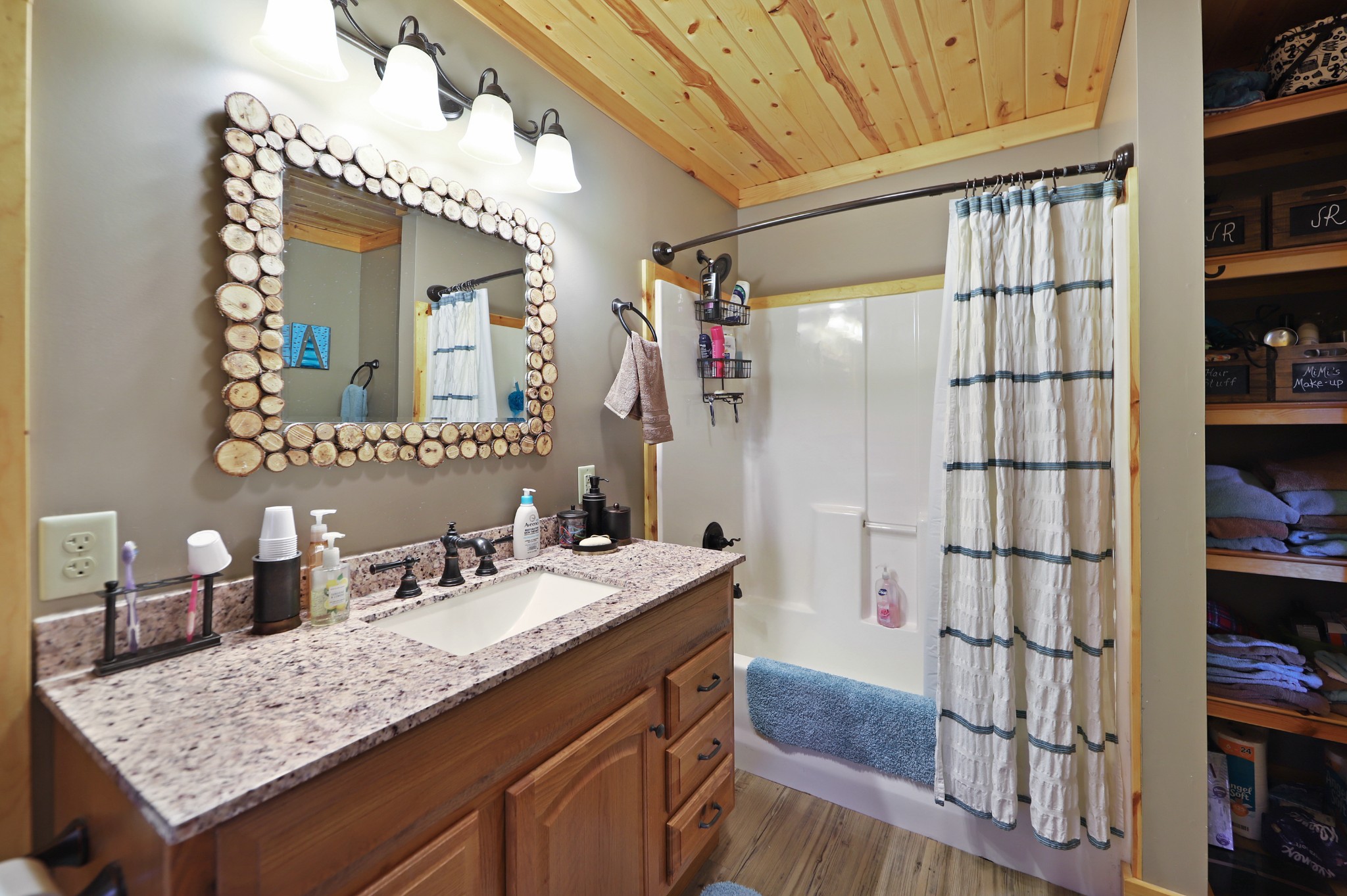 3686 Bluebird Road Lebanon, TN 37090 - Photo 35 of 50 a bathroom with a granite countertop sink a mirror and shower