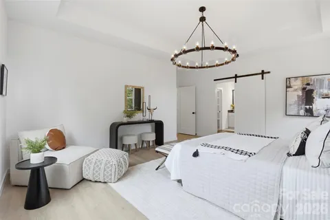 a bedroom with a bed a table and chair
