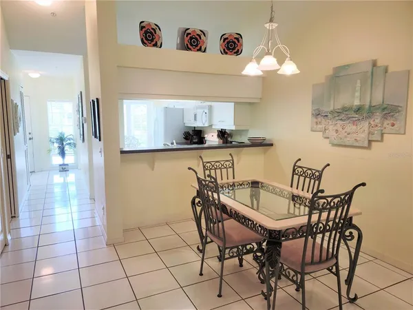 a kitchen with stainless steel appliances a table and chairs in it