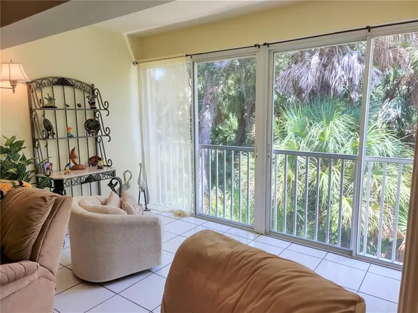 a living room with furniture and a large window with outer view