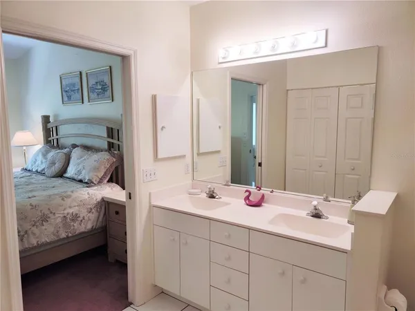 a bathroom with a double vanity sink and a mirror