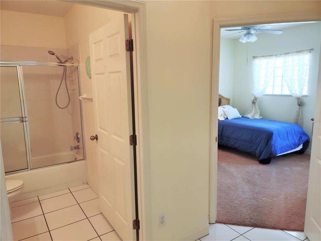Undisclosed Address Venice, FL 34292 - Photo 37 of 51 a bedroom with a bed and a shower