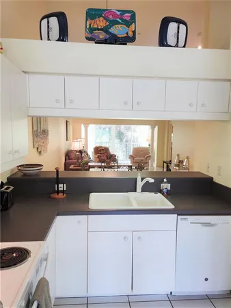 a kitchen with a sink and white cabinets