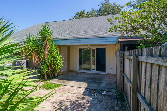 a front view of a house with a yard and lake view