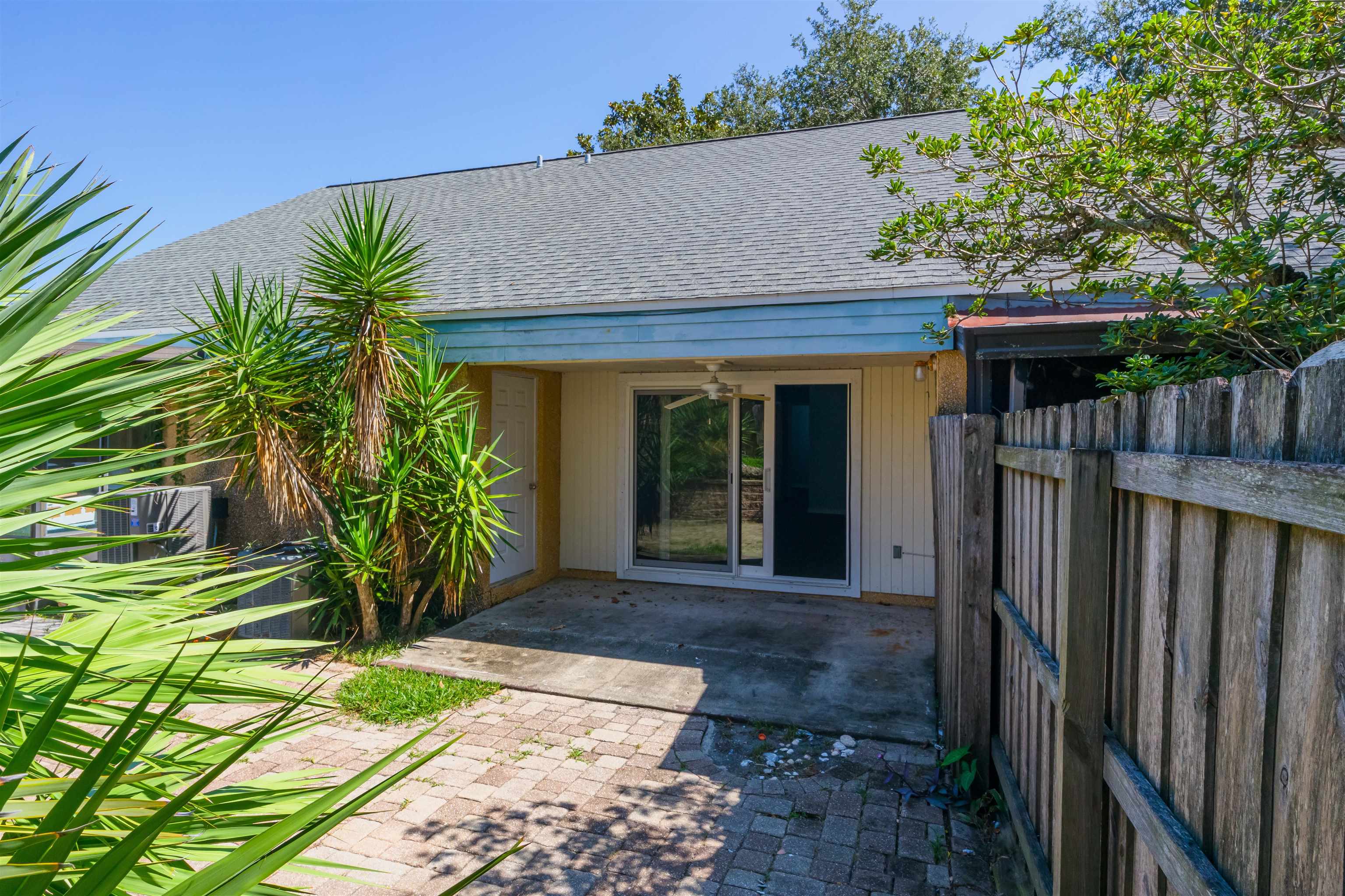 4703 Sandcastle Circle St. Augustine, FL 32084 - Photo 13 of 14 a view of a house with a small yard plants and wooden fence
