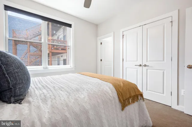 a bathroom with a granite countertop toilet sink and mirror