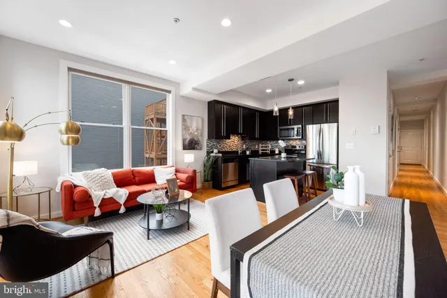 a kitchen with kitchen island a counter top space cabinets and stainless steel appliances