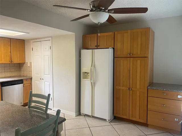 a kitchen with a sink a counter and cabinets