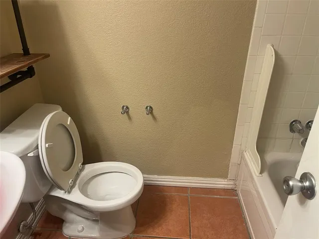 a bathroom with a sink mirror and toilet