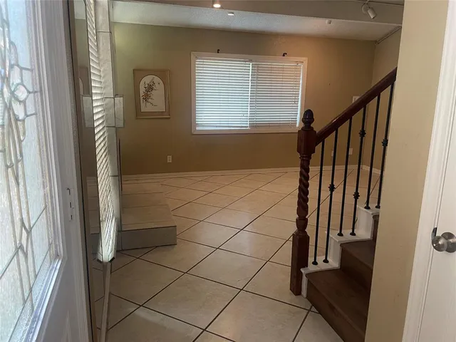 a kitchen with granite countertop a sink a stove top oven and cabinetry