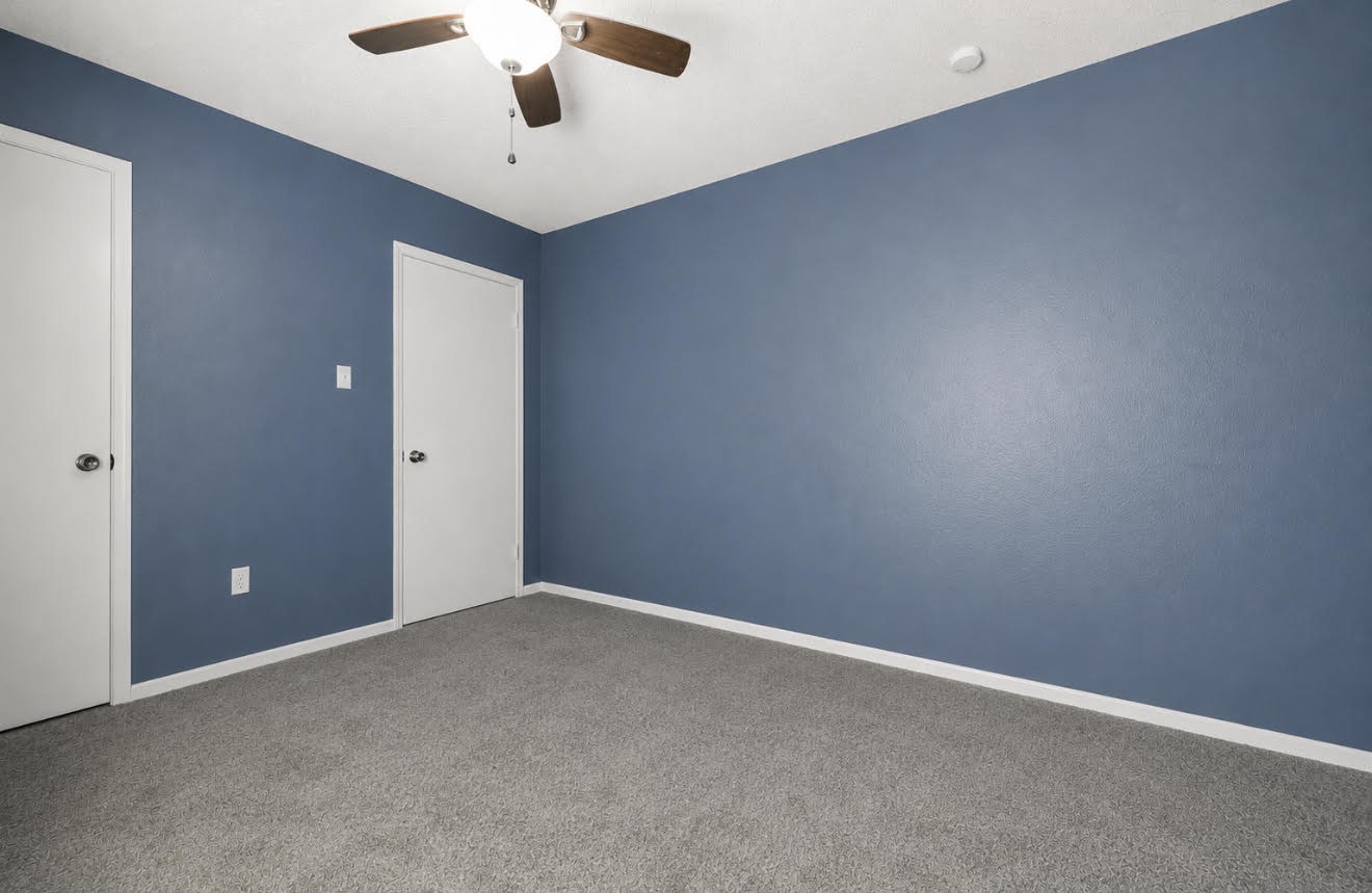 3728 Autumn Lane Baytown, TX 77521 - Photo 12 of 16 This room features a clean, modern design with blue walls, gray carpet, and a ceiling fan.