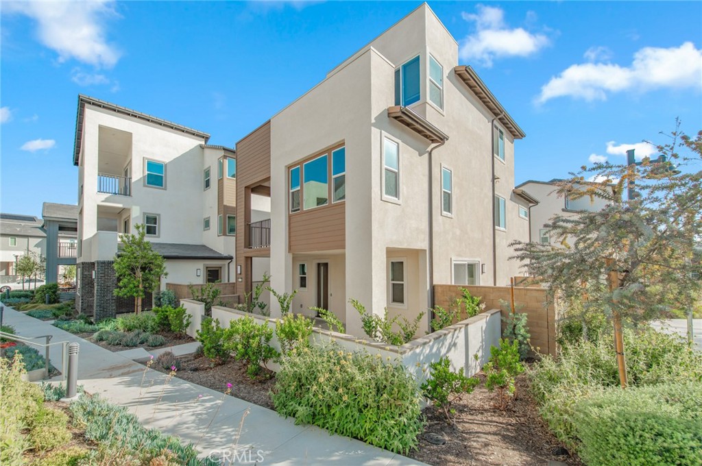 110 Seep Irvine, CA 92618 - Photo 1 of 37 a front view of a multi story residential apartment building with yard and parking