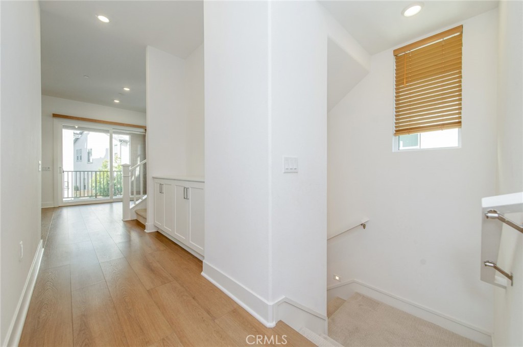110 Seep Irvine, CA 92618 - Photo 11 of 37 a view of an empty room with wooden floor and a window